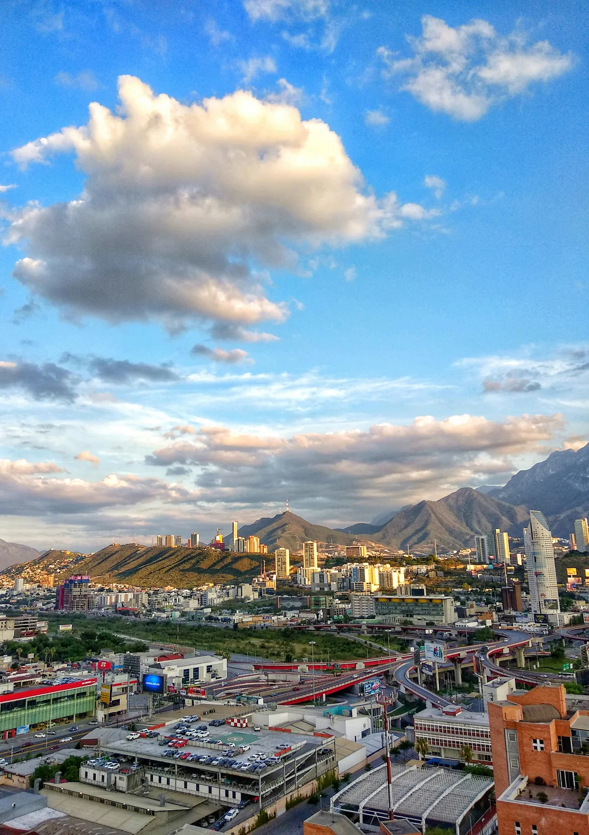 Monterrey cityscape with the Sierra Madre mountain range and Cerro de la Silla peak as a dramatic backdrop, home city of Estadio BBVA