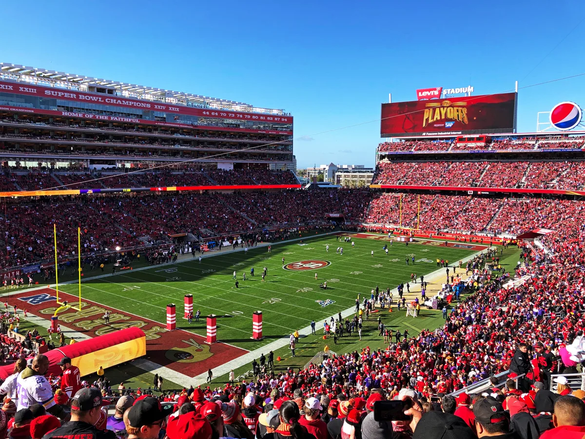 Levi's Stadium interior packed with fans wearing red filling every tier on a sunny matchday in Santa Clara, San Francisco Bay Area
